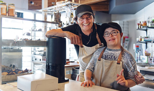 person with disability and their co-worker working in a small business